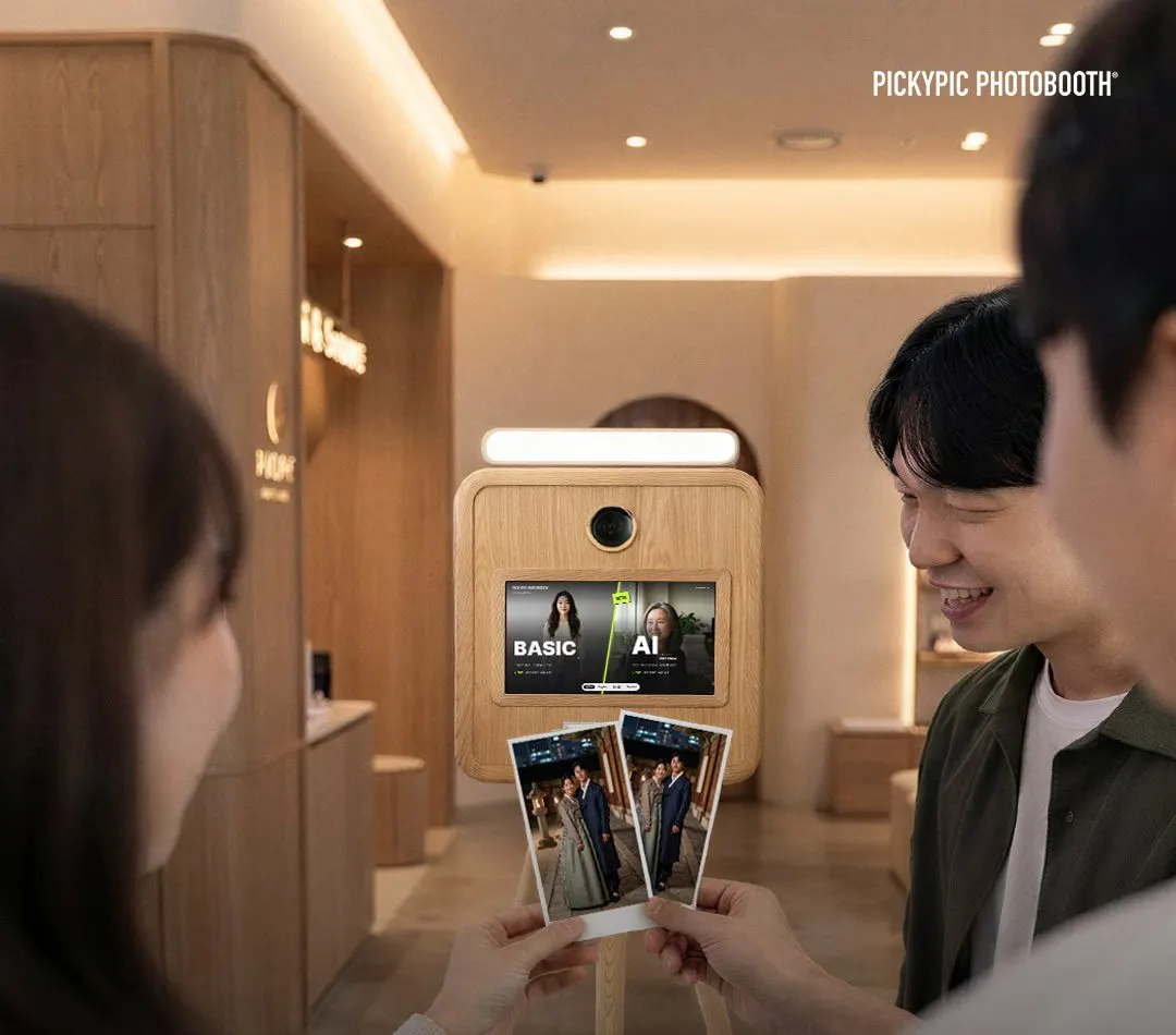 Guests holding two AI prints in front of a wooden PickyPic booth